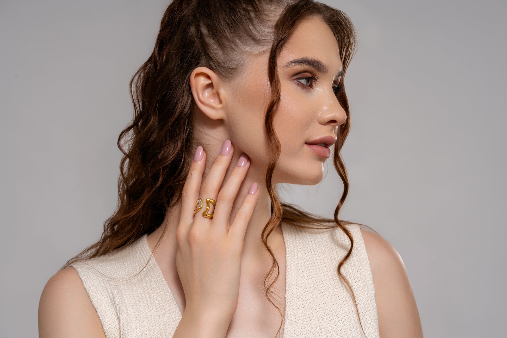 Model wearing Gilded Spark Ring, highlighting its bold gold curves and crystal embellishment, suited for statement jewelry lovers.