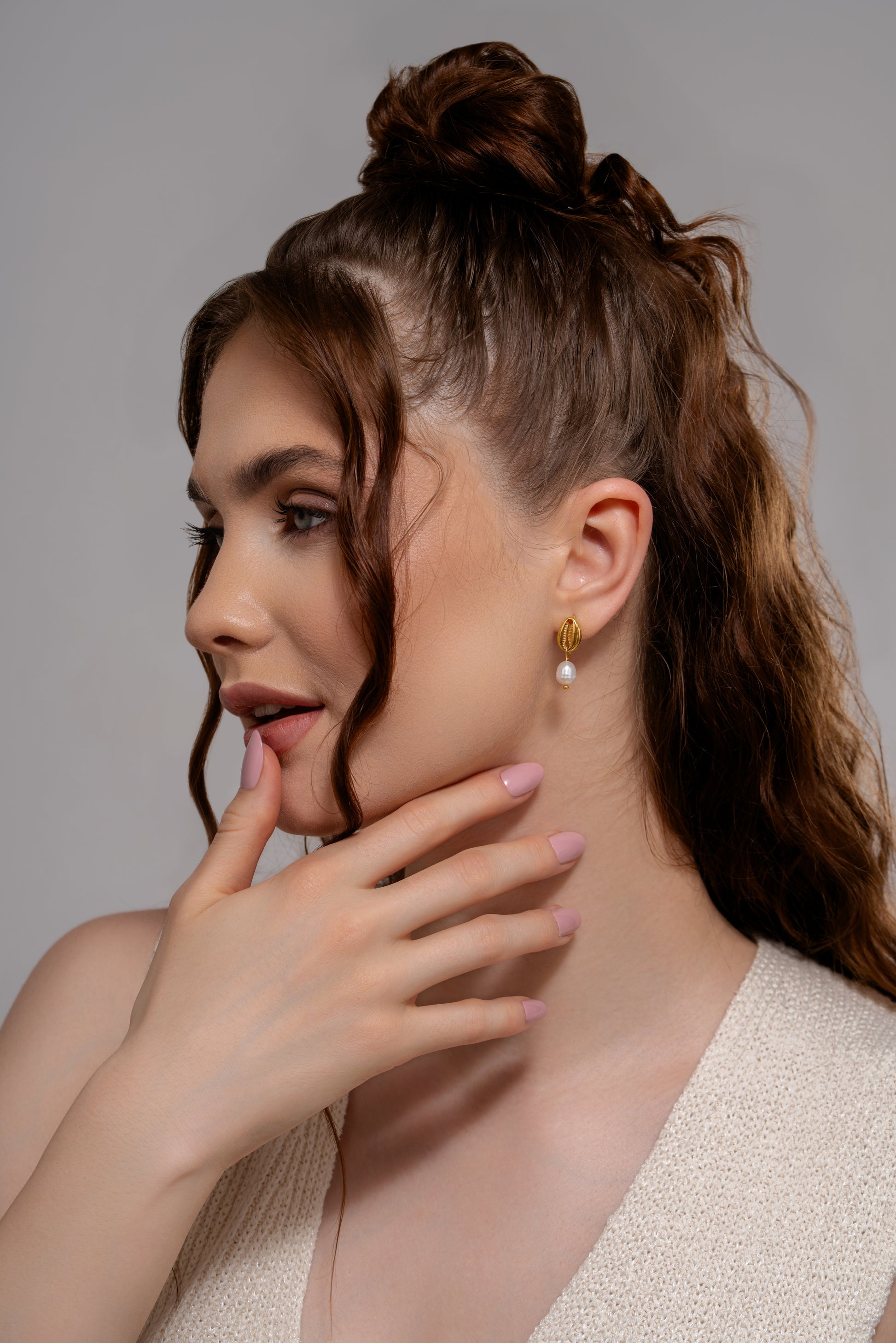 Model wearing Ocean's Embrace Pearl Earrings, showcasing elegant gold and pearl drop design perfect for summer and coastal fashion styles.