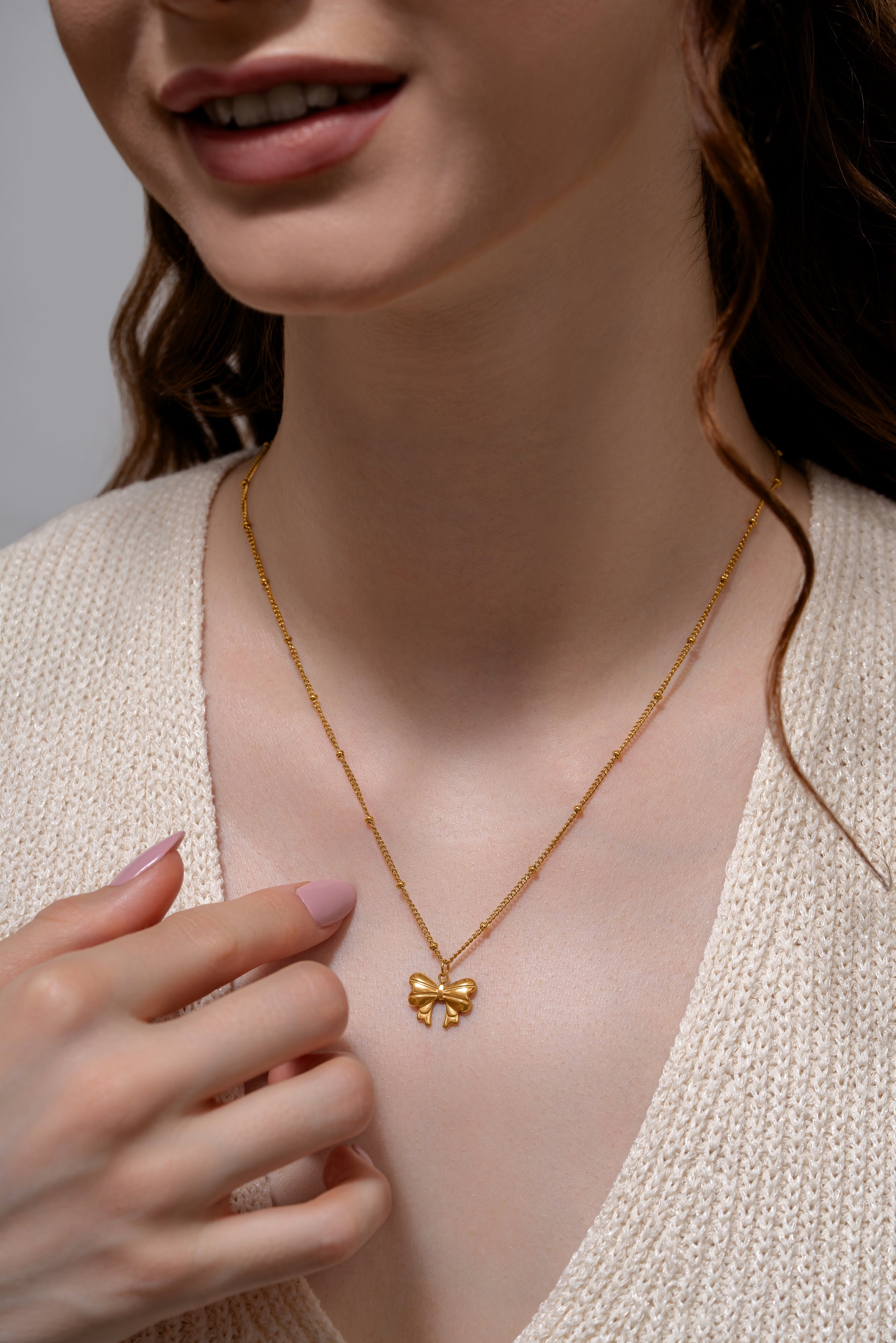 Model wearing Glimmerwing Gold Necklace with butterfly charm, showcasing its refined design and feminine appeal for jewelry lovers.