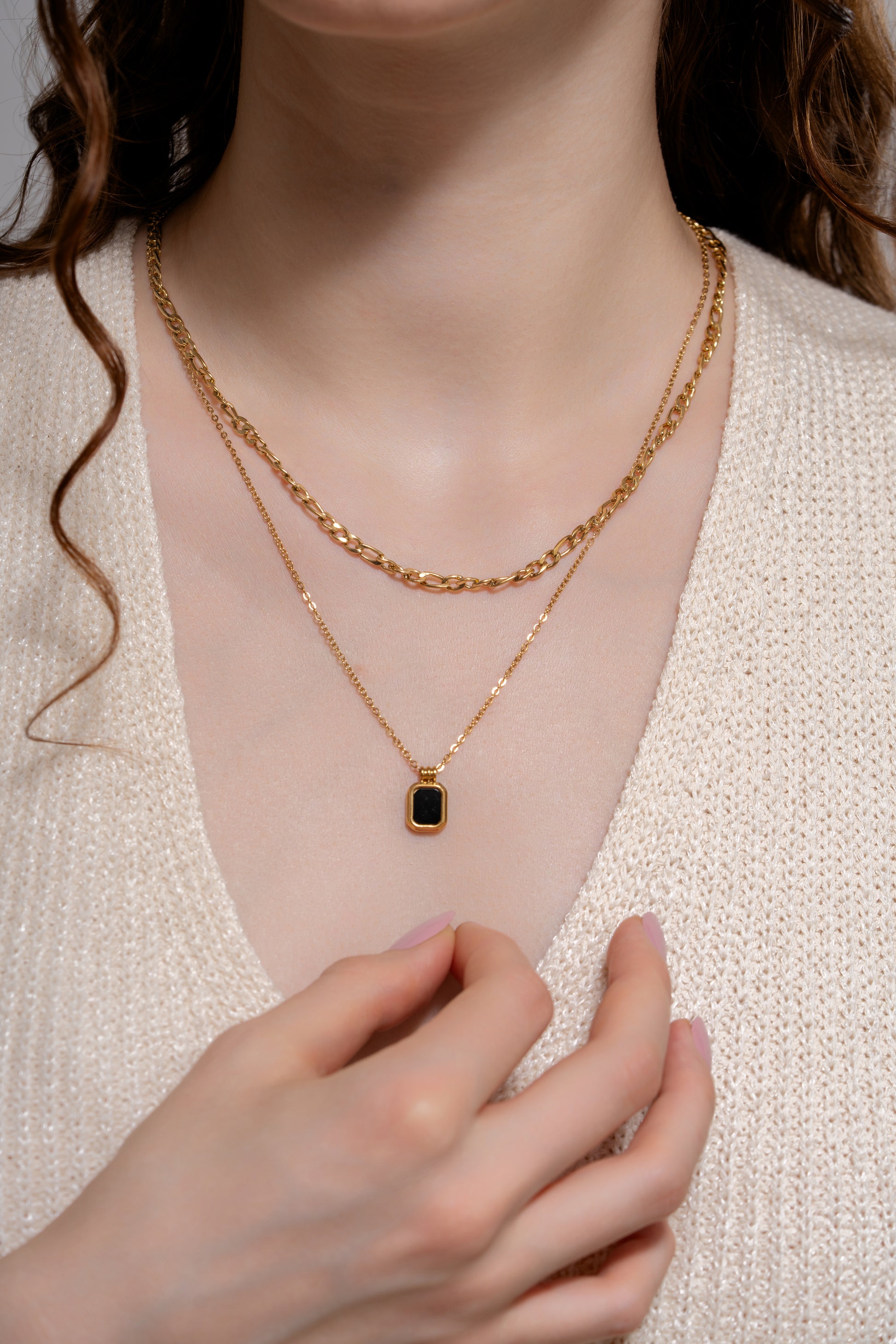 Black Onyx Layered Necklace worn on model, showcasing the gold chain layers and black gemstone pendant for chic accessory appeal.