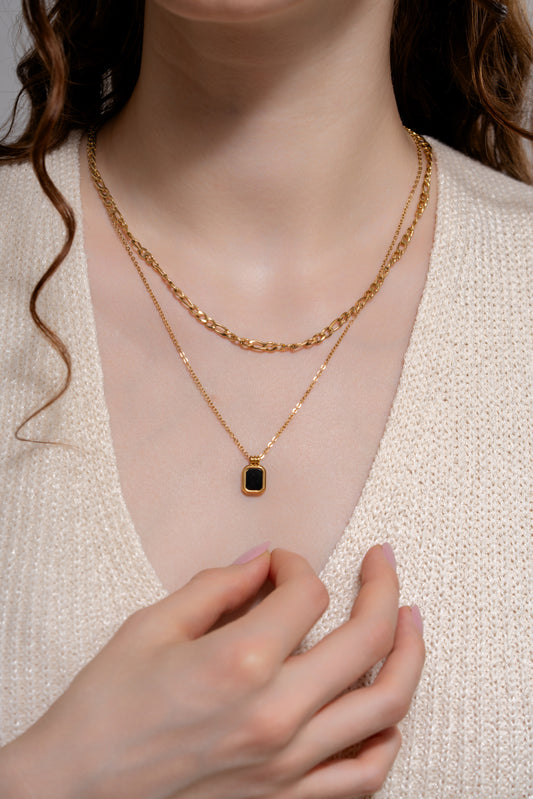 Black Onyx Layered Necklace worn on model, showcasing the gold chain layers and black gemstone pendant for chic accessory appeal.