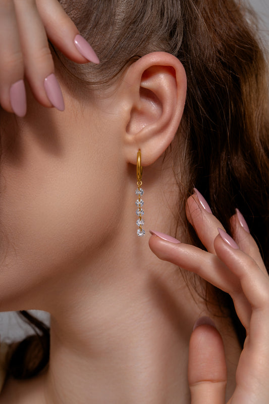 Loop Crystal Chain Hoops worn on model showcasing gold hoops with cascading crystal chain, ideal for chic and modern looks.