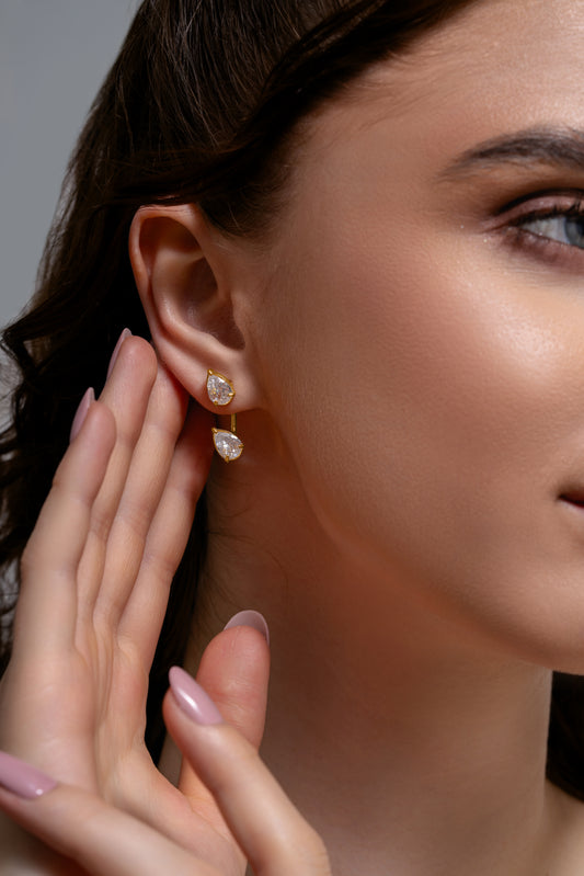 Model wearing Double Pear Earrings with two pear-shaped stones, showcasing their stylish drop design for fashion-forward accessorizing.