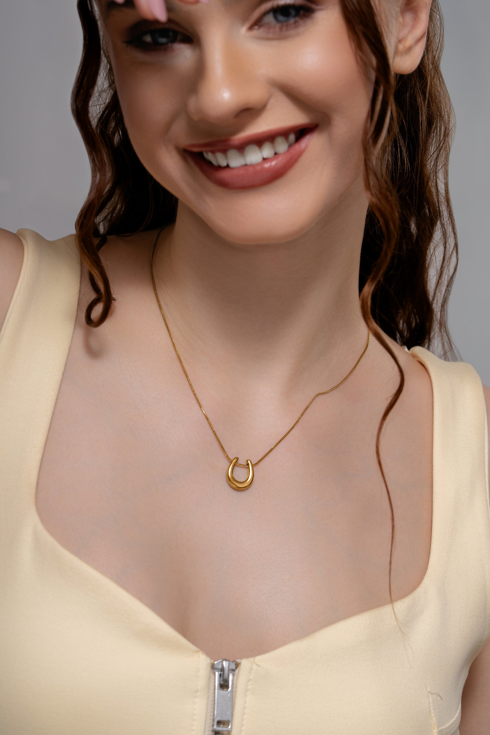 Close-up of Luna Charm Necklace on model, highlighting the elegant gold crescent pendant for fashion jewelry appeal.