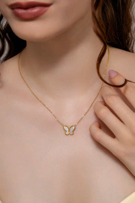 Model wearing Delicate Butterfly Pendant Necklace, showcasing its elegant gold chain and dainty butterfly charm on neckline.