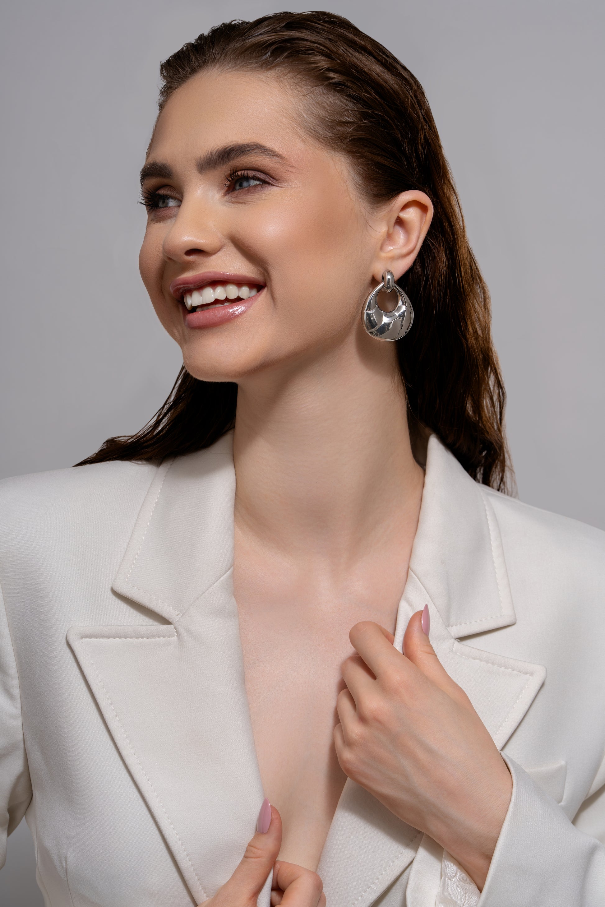 Model wearing Twirléa Sterling Hoops styled with a white blazer. Statement silver earrings perfect for formal or evening wear.