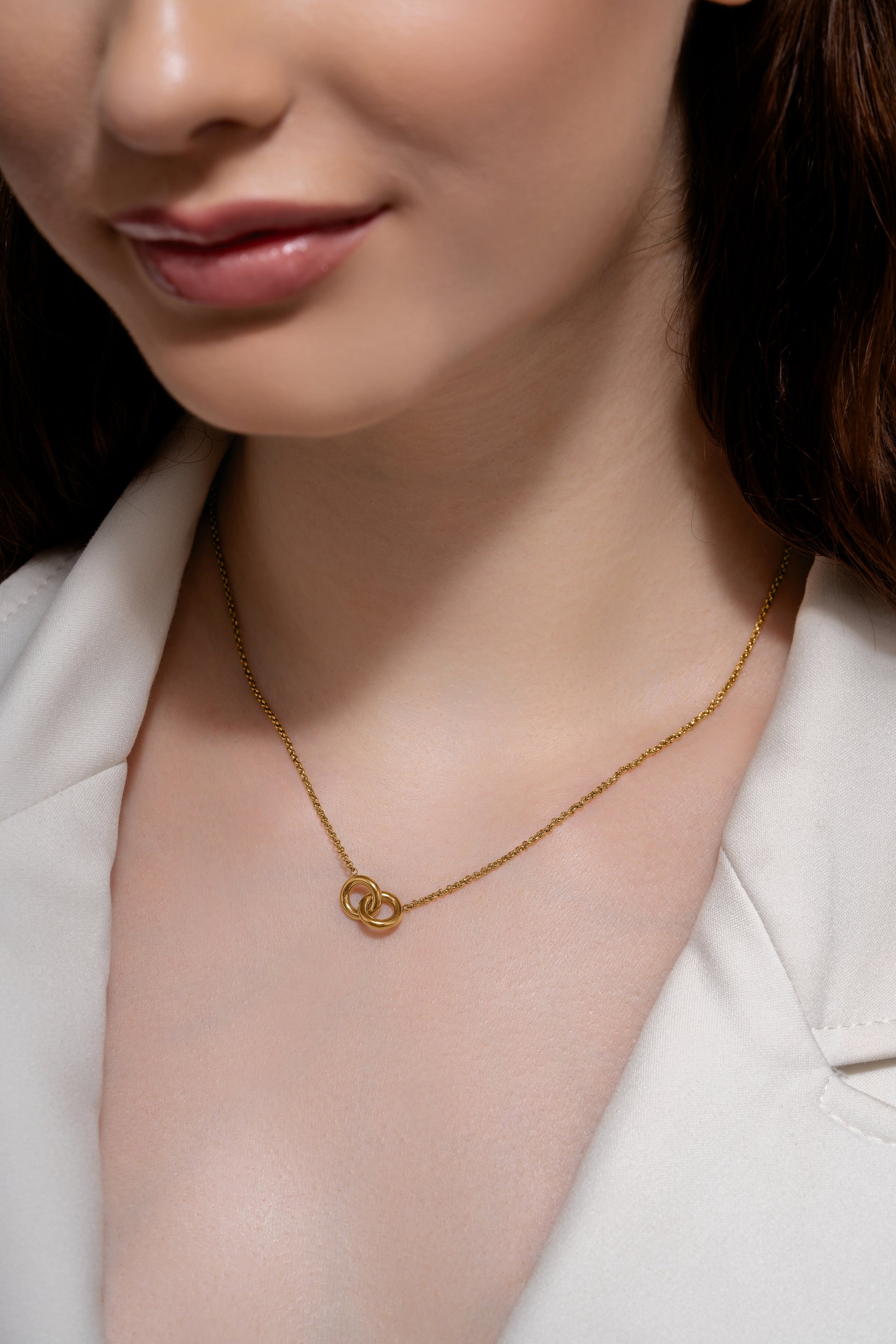 Model wearing the Eternal Grace Necklace with interlocking gold circles, showcasing its delicate design for the jewelry and accessories category.