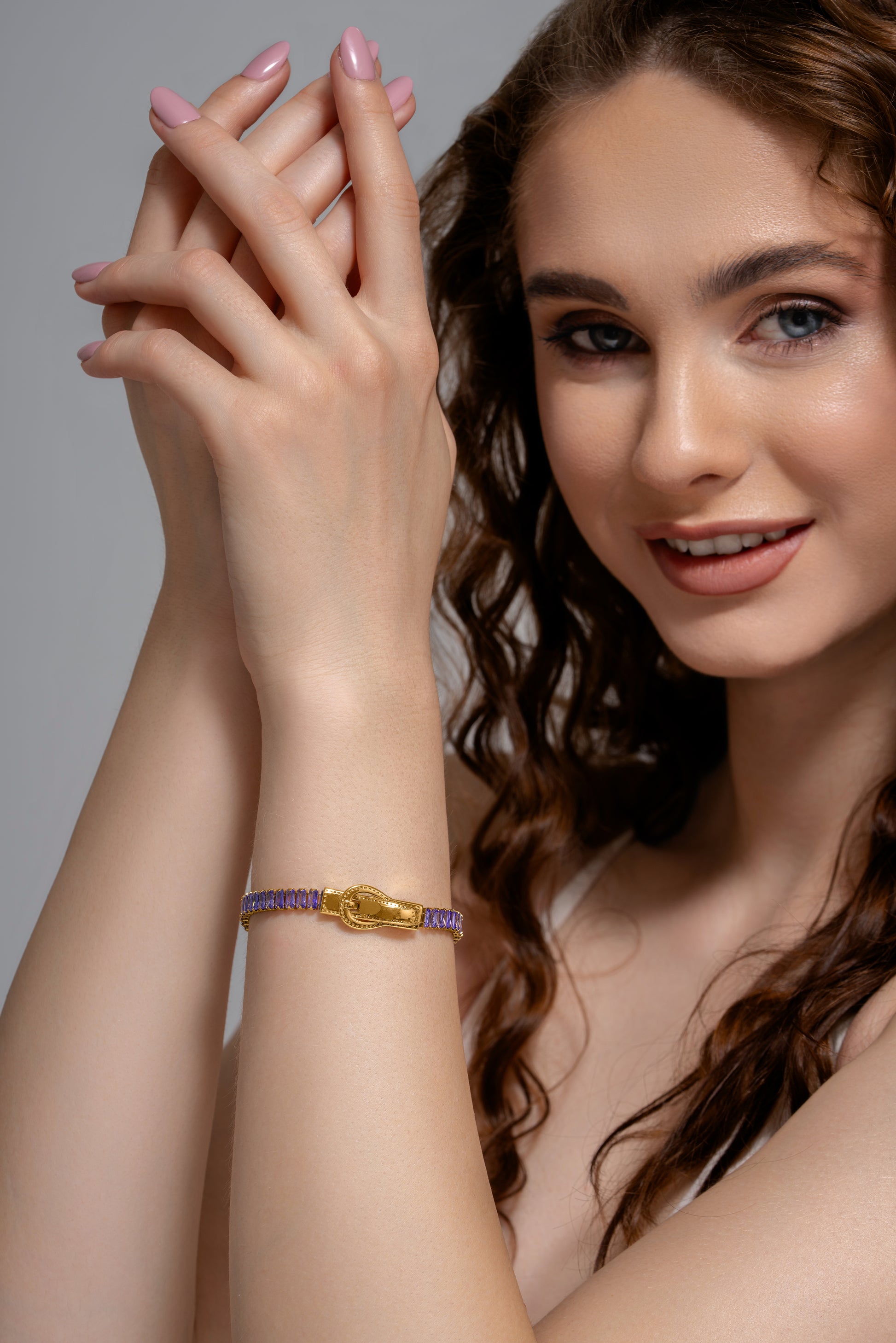 Model showcasing Baguette Tennis Bracelet with gold zipper design and purple baguette stones, ideal for fashion-forward jewelry collections.
