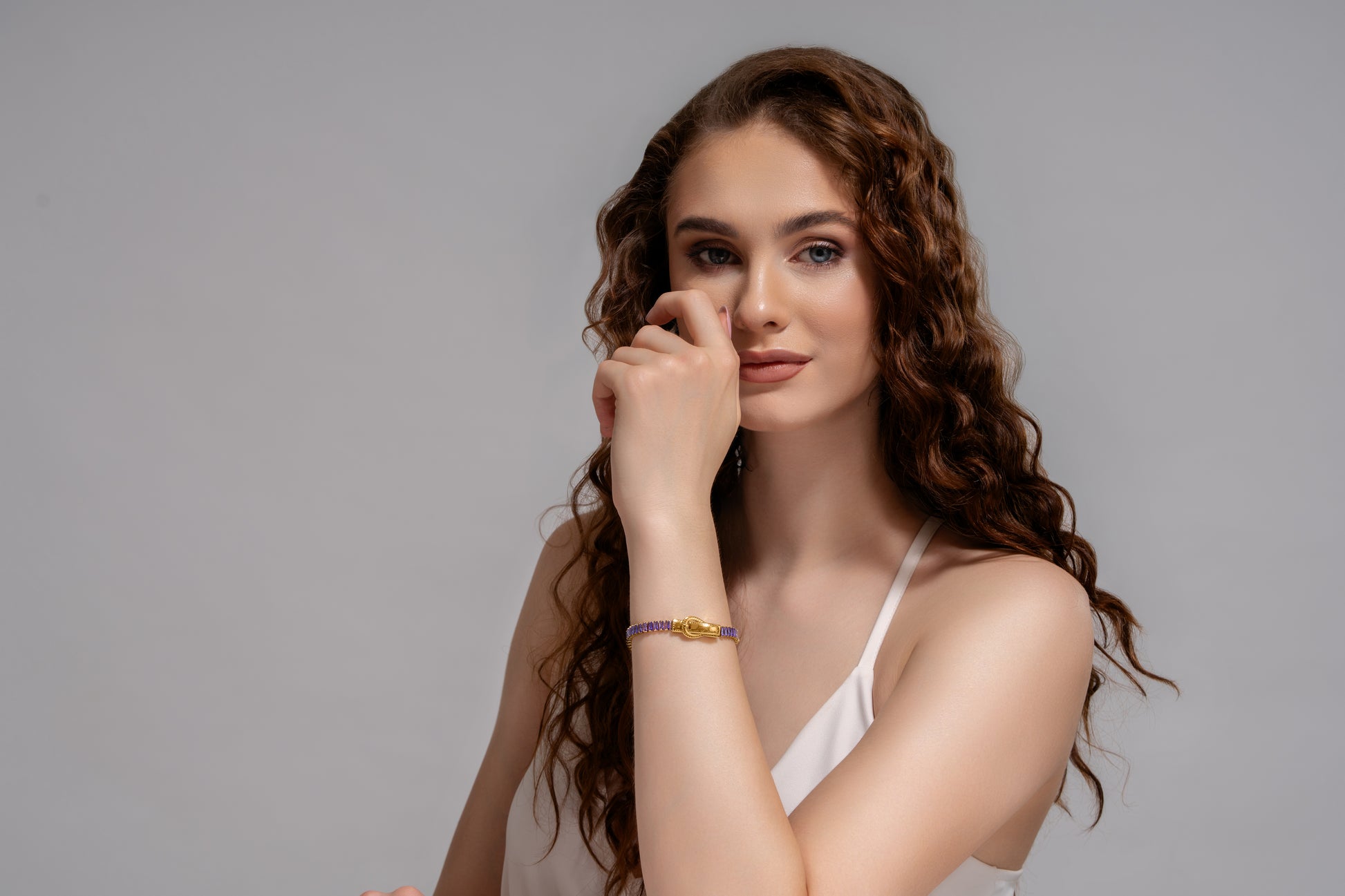 Elegant woman wearing Baguette Tennis Bracelet with gold and purple detailing, a stylish piece in the jewelry and accessories category.