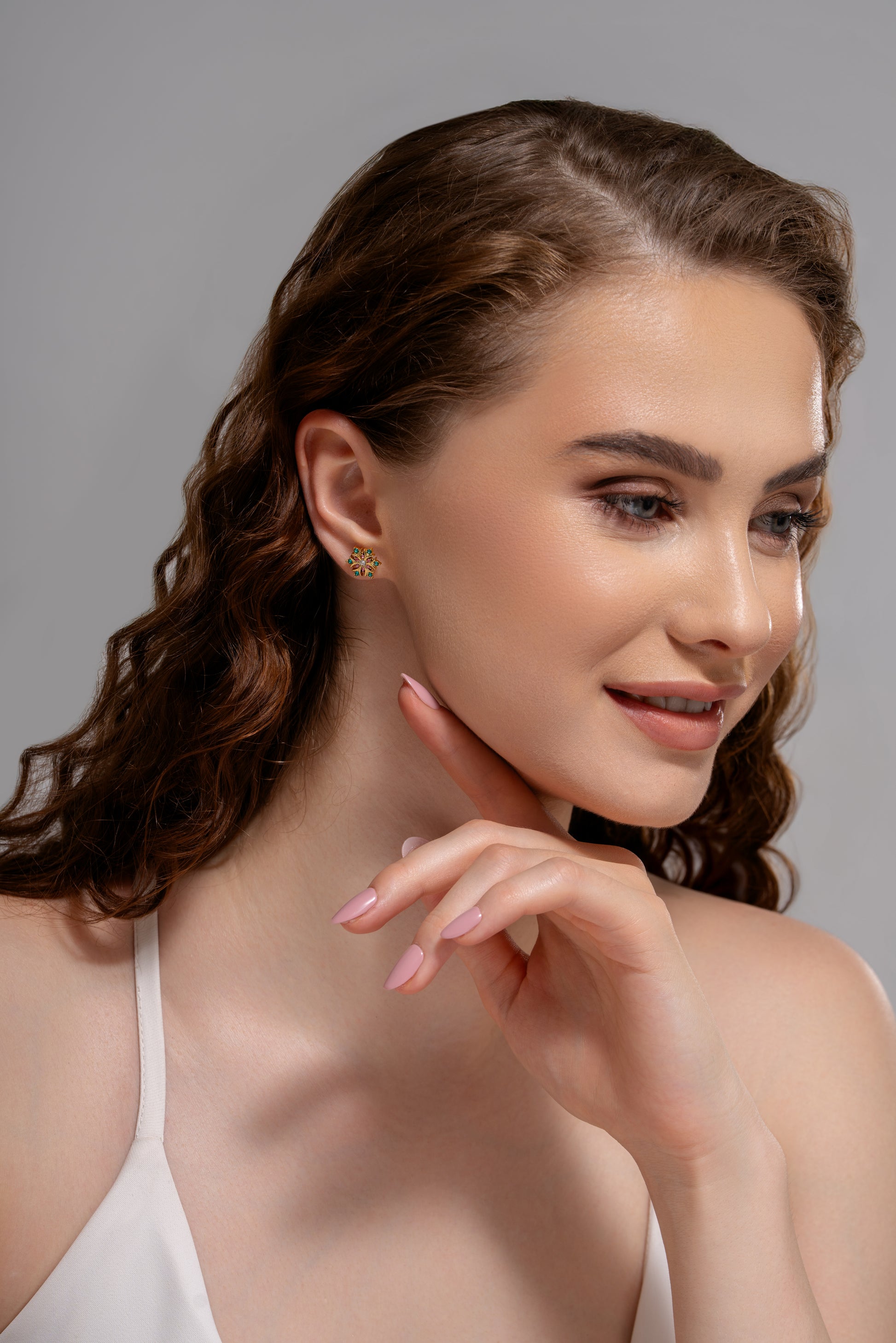 Model wearing Petal Radiance Studs, showcasing their vibrant gemstone detailing and delicate floral shape for a chic accessory look.