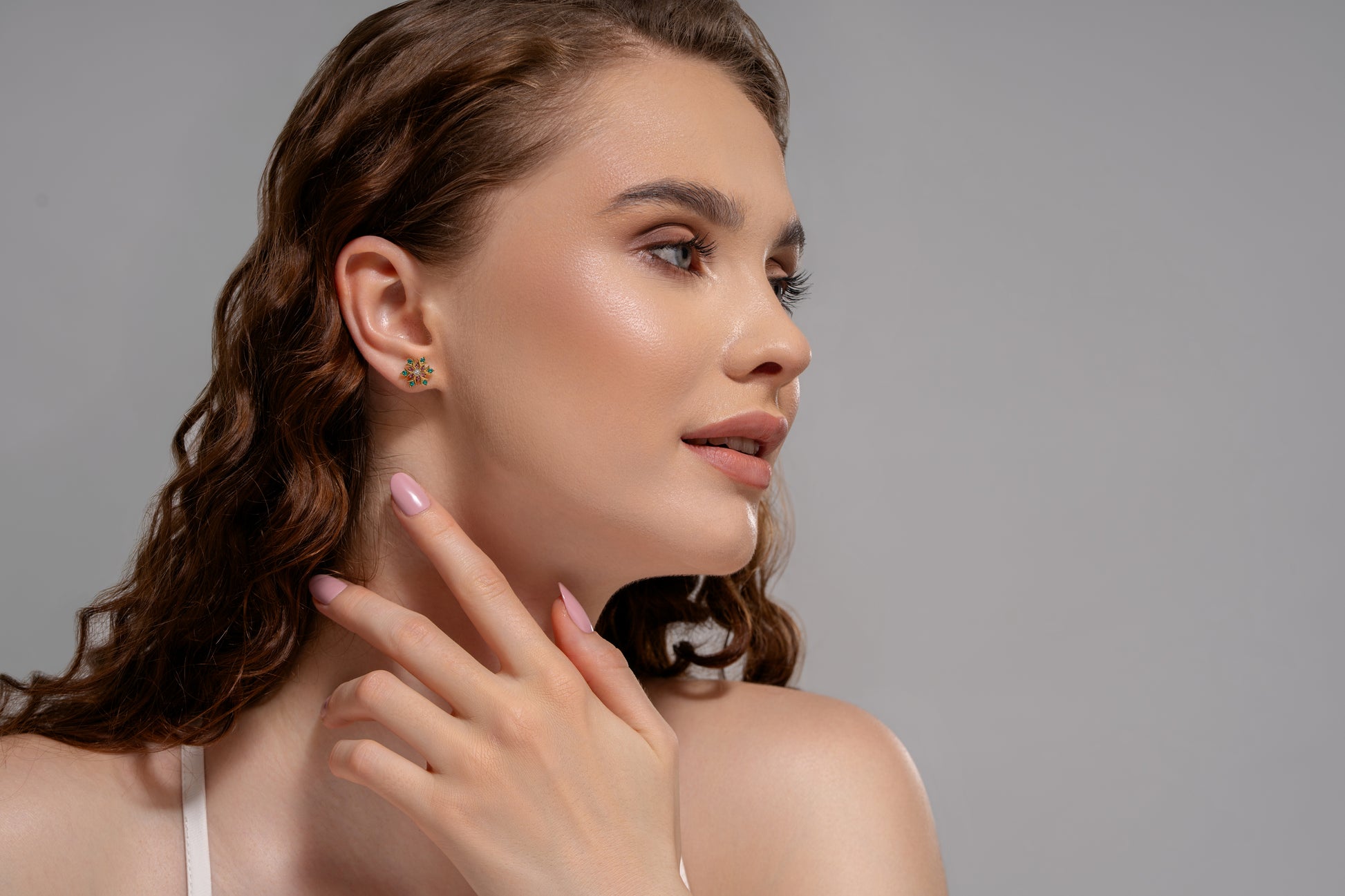 Close-up of model displaying Petal Radiance Studs, emphasizing their colorful sparkle and refined floral design in a fashion-forward style.