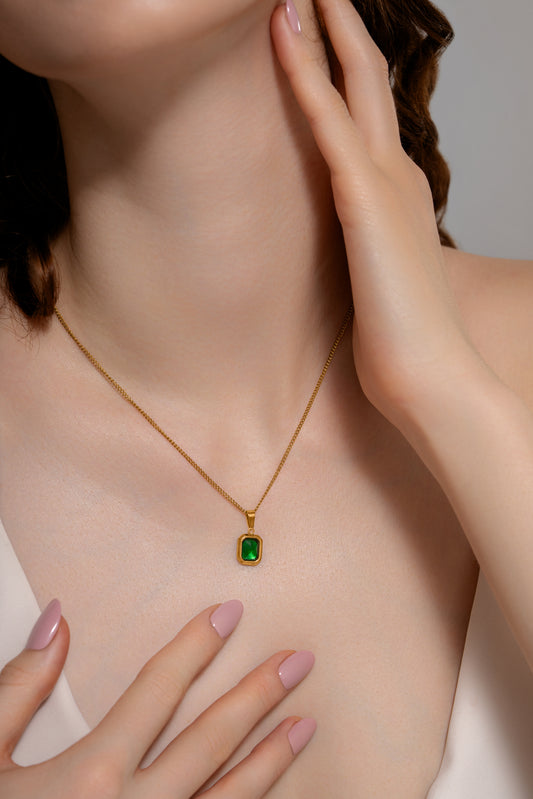 Classic Emerald Necklace worn close-up, showcasing the vivid green gemstone pendant and gold chain, perfect for formal or casual outfits.