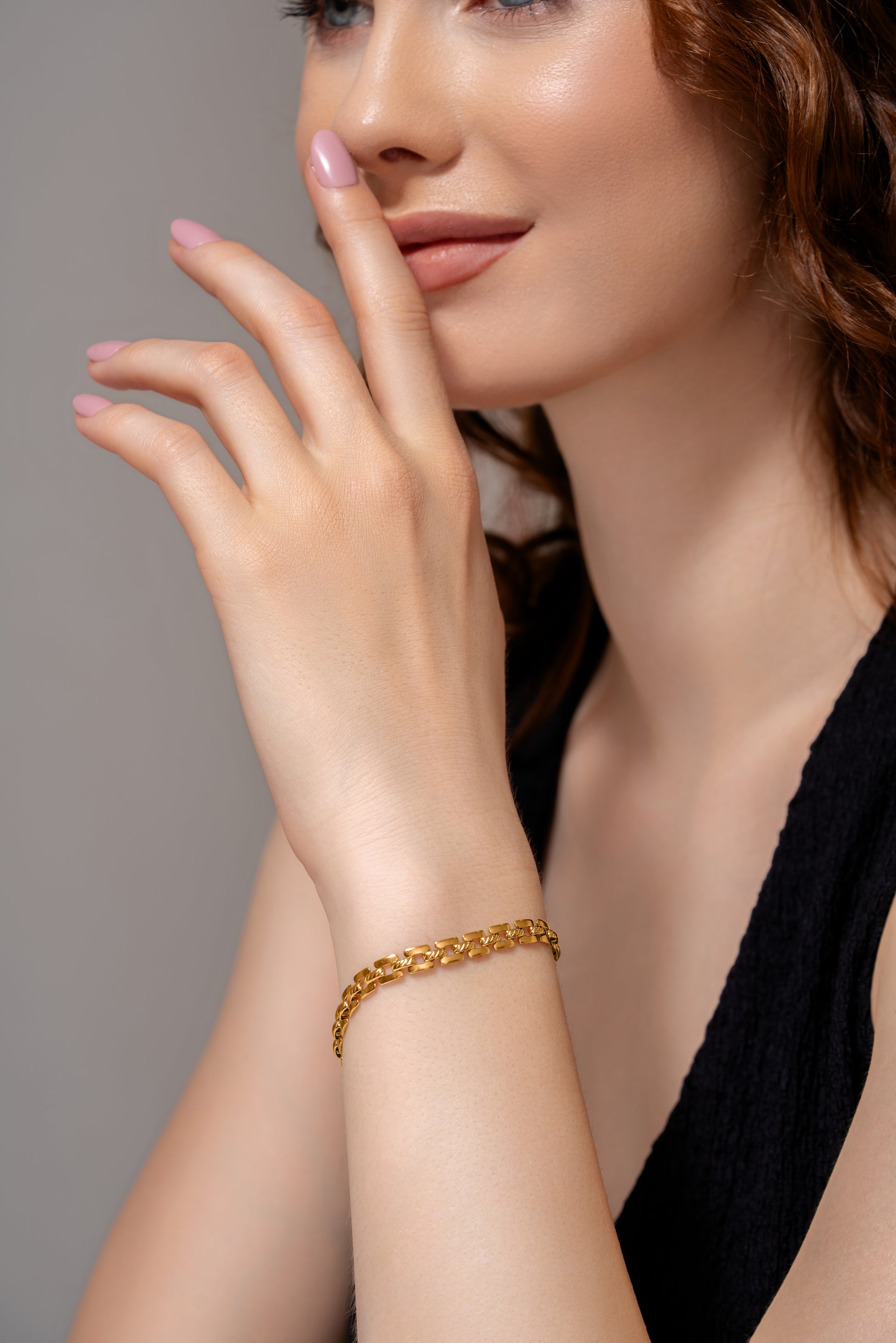 Close-up of Stackable Radiance Bracelet on wrist, emphasizing its polished gold links and refined accessory style.