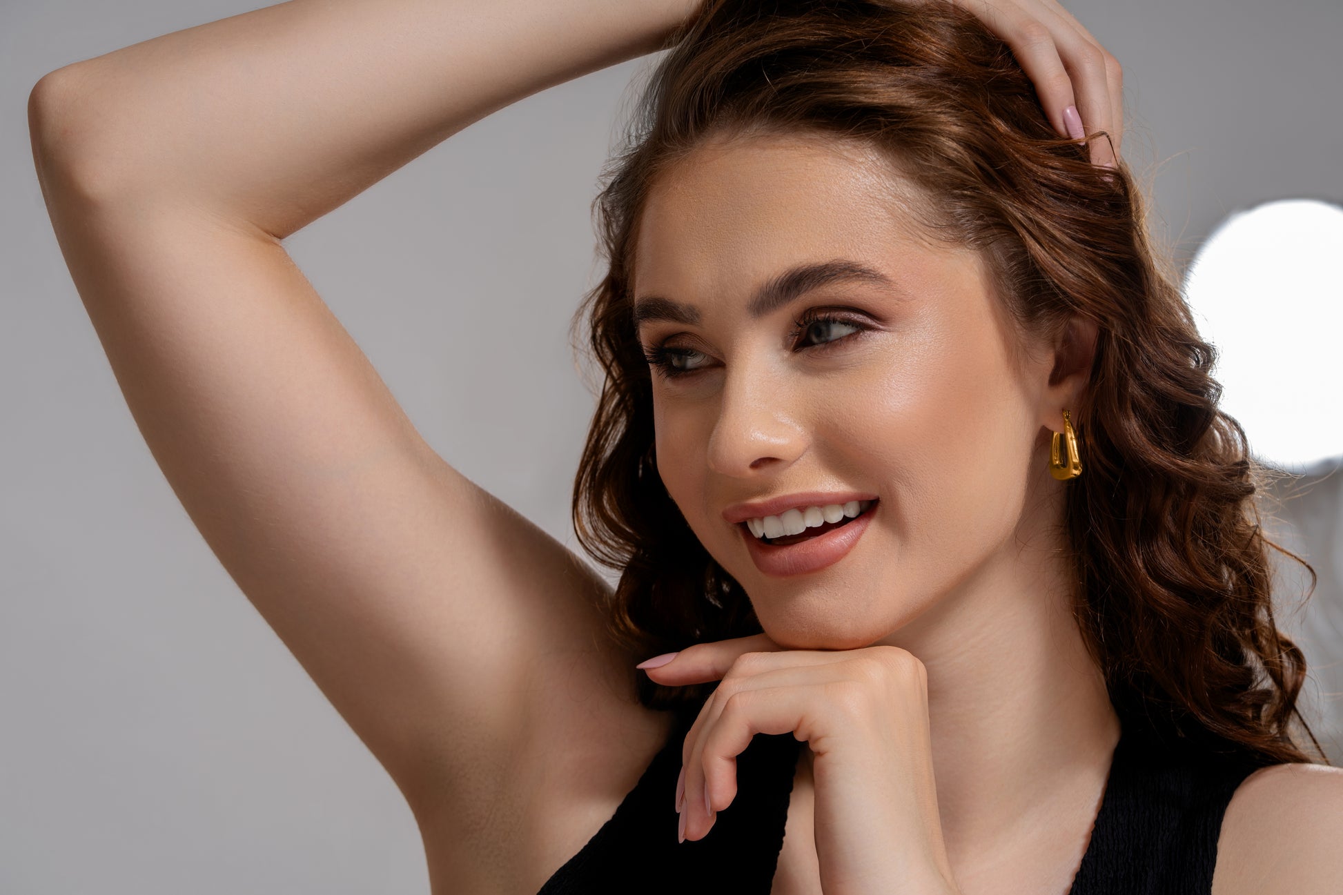 Triangular Hoop Earrings styled on model with curled hair, showcasing their elegant gold tone and modern geometric appeal.