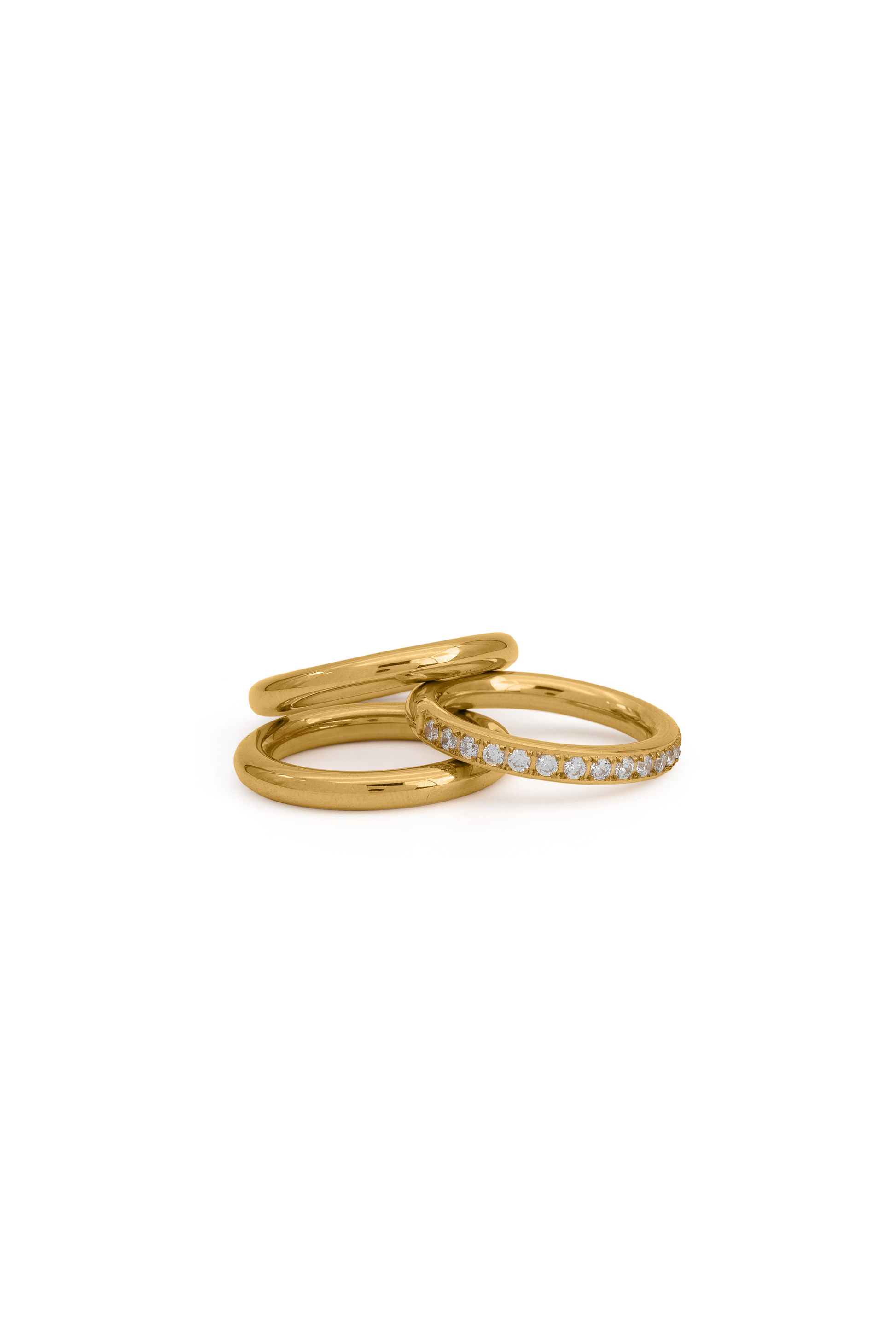 Celestial Trio gold ring set featuring two polished bands and one pavé diamond band, ideal for stacking in fine jewelry collections.
