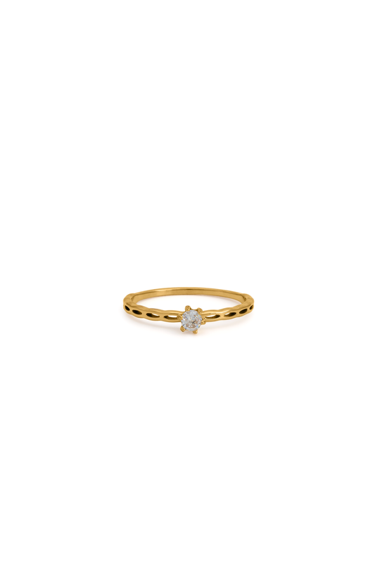 Celeste Dot Band Ring in gold with a central gemstone, featuring a delicate dotted band design. Perfect for minimalist jewelry lovers.