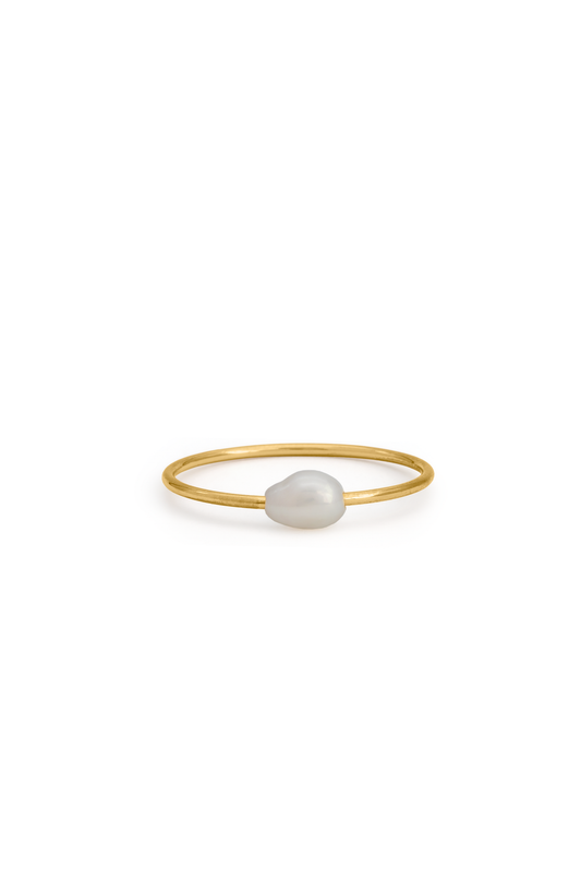 Celeste Pearl Ring featuring a delicate gold band with a single natural pearl, ideal for minimalist jewelry collections.