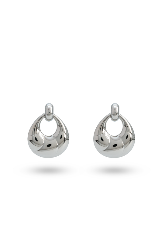Twirléa Sterling Hoops in polished silver finish with a sculptural, twisted design. Elegant earrings for modern jewelry collections.