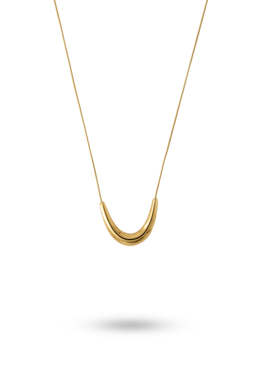 The Arc gold necklace featuring a sleek, curved pendant on a fine chain, ideal for minimalist jewelry lovers in the necklaces category.