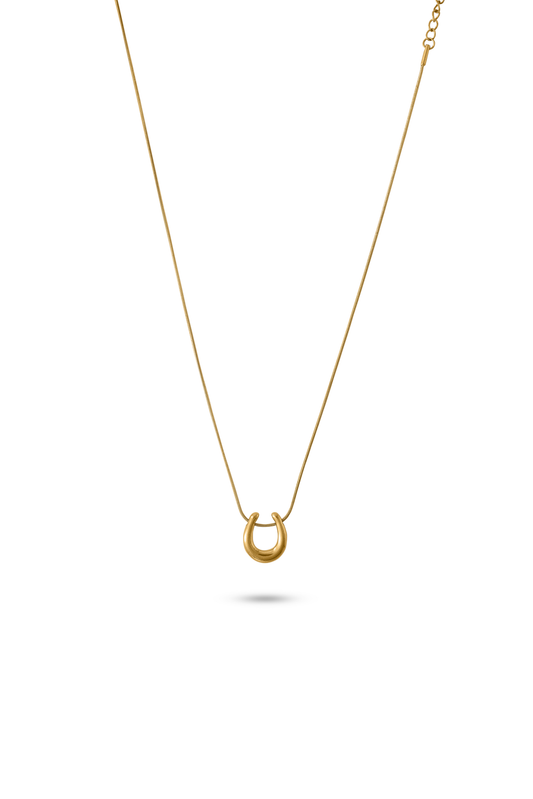 Luna Charm Necklace in gold with a minimalist crescent pendant, displayed on a white background for jewelry product showcase.
