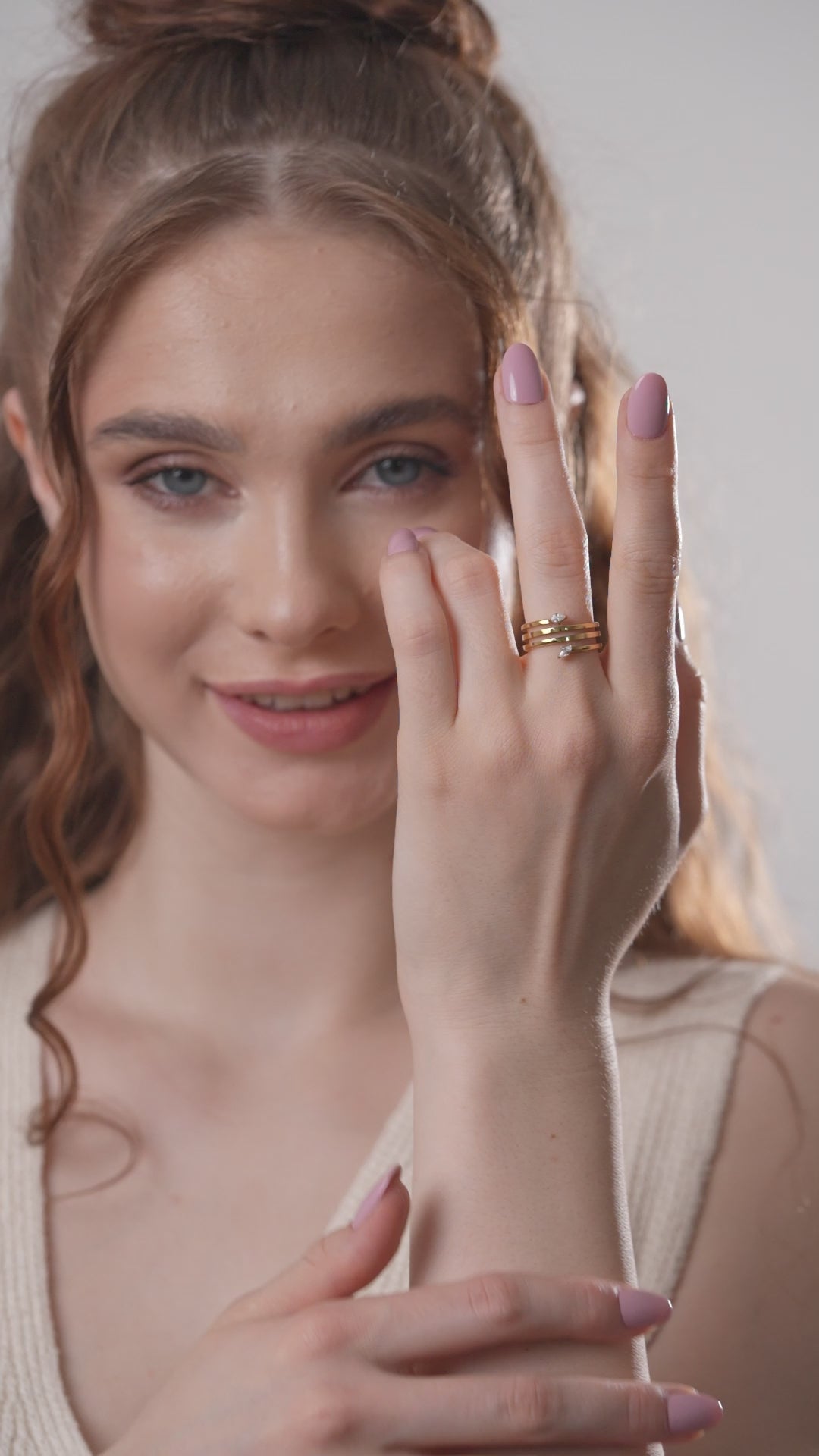 Model presenting the Twist Glow Open Ring with a hand gesture, displaying its luxurious gold tone and crystal-tipped open design.