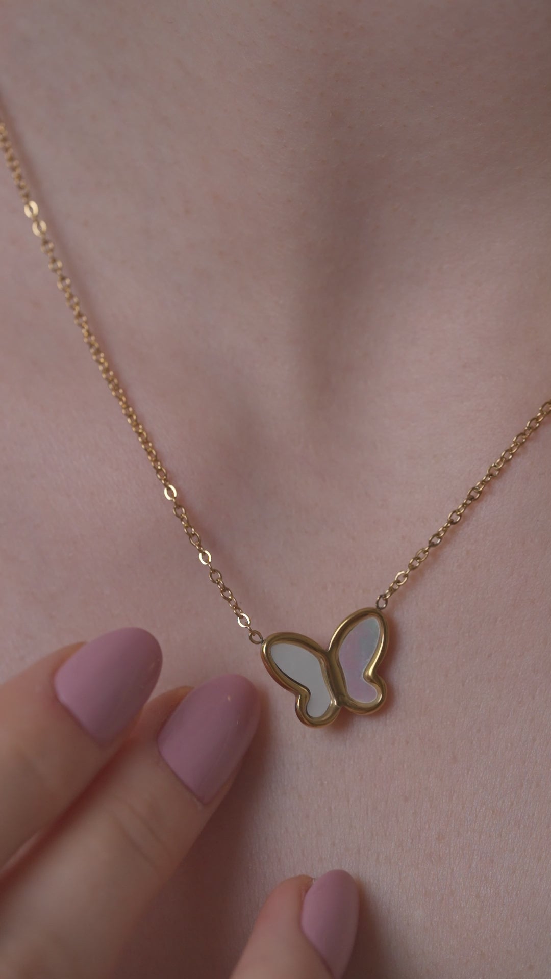 Zoomed-in view of Delicate Butterfly Pendant Necklace on skin, emphasizing the intricate butterfly charm and gold chain texture.