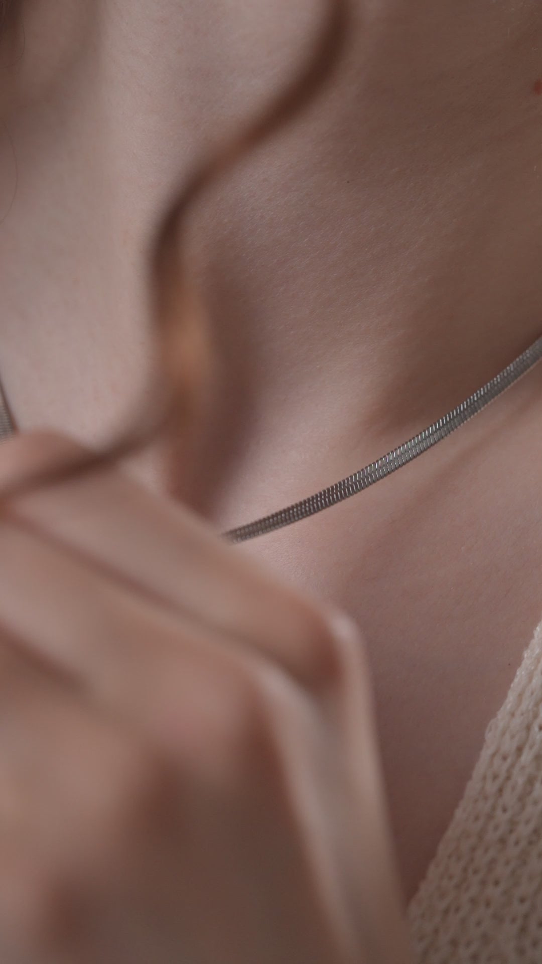 Close-up of Luxe Snake Chain on a woman's neck, emphasizing the fine texture and minimalist style of this elegant silver necklace.