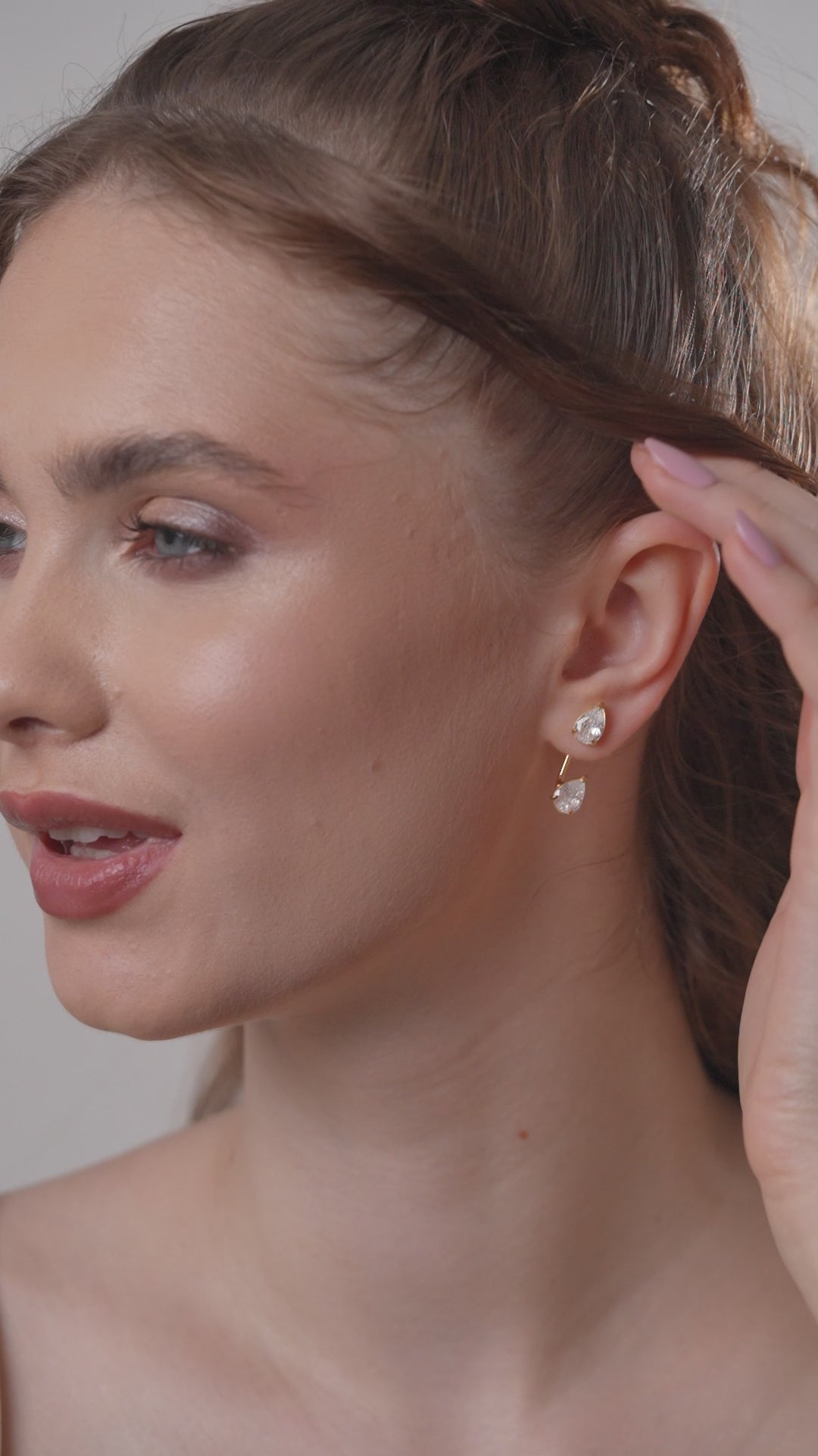 Close-up of model wearing Double Pear Earrings, emphasizing the elegant dual-stone drop design for luxury jewelry appeal.