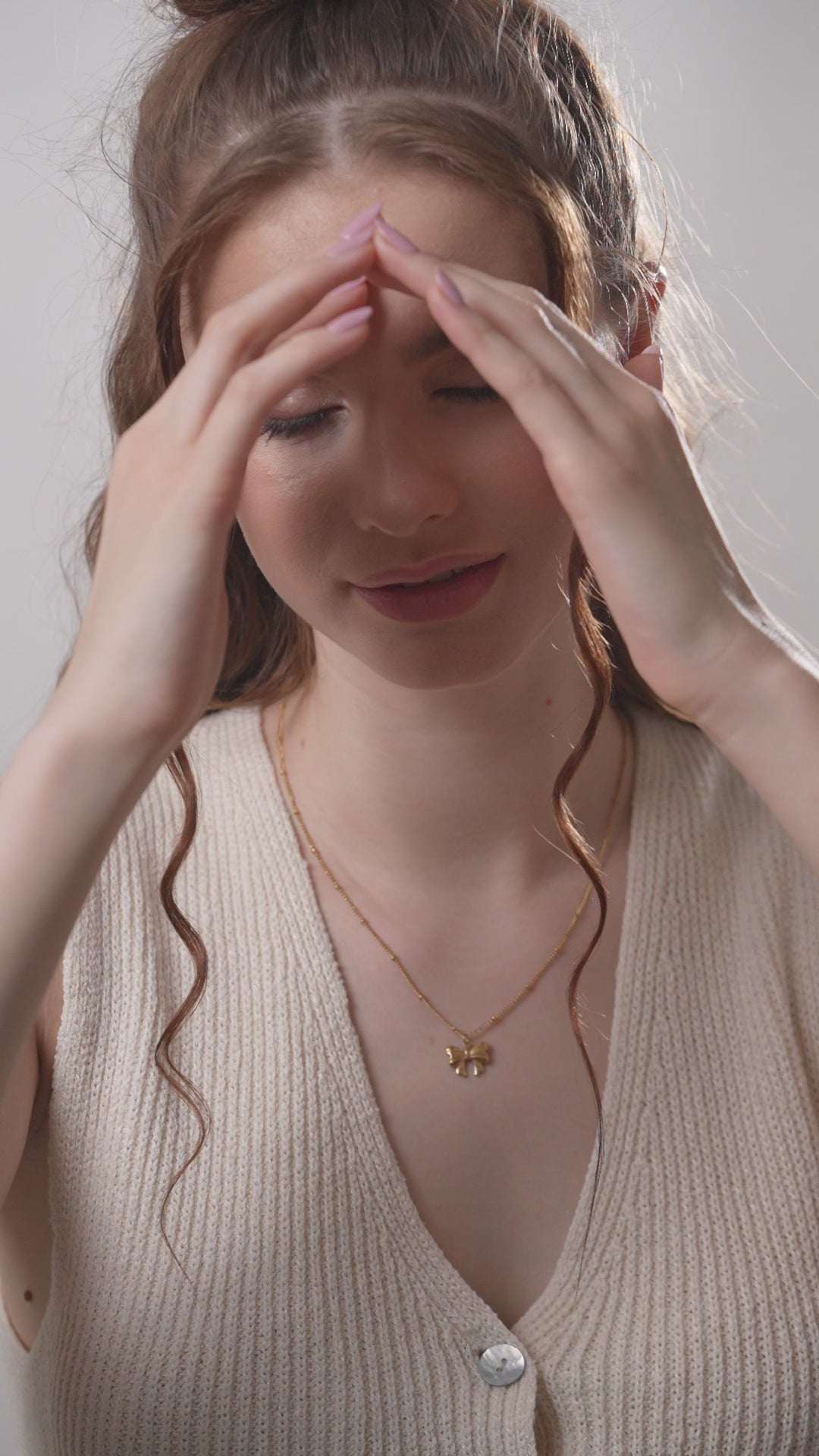 Glimmerwing Gold Necklace worn by a model in a beige knit top, emphasizing the necklace's subtle elegance and versatile style.