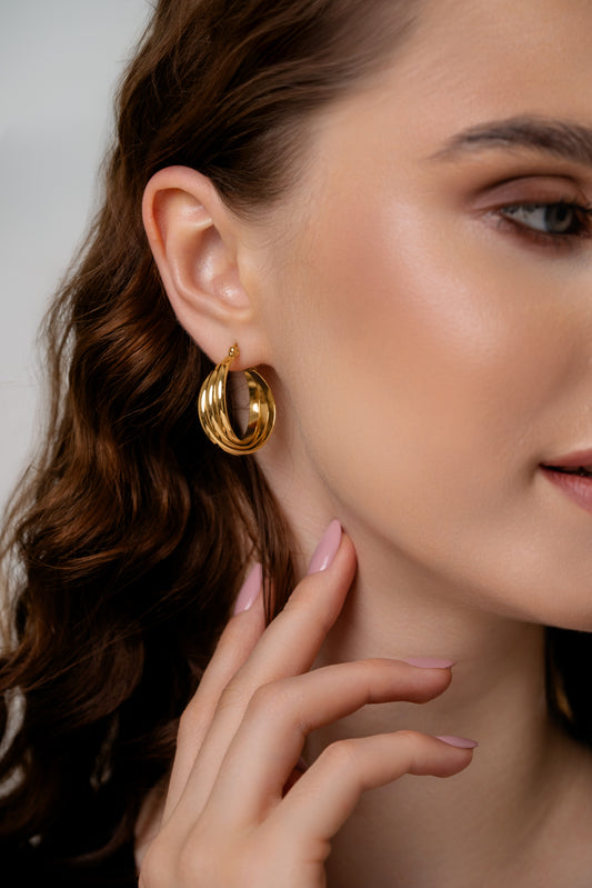 Close-up of Refined Oval Hoop Earrings in gold, highlighting the polished finish and layered oval design. Perfect for stylish everyday wear.